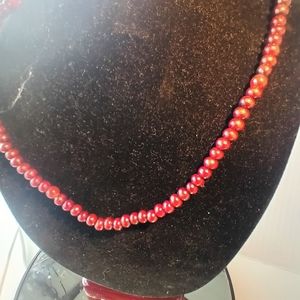 Dark Red beaded necklace with pretty corded tie, it is a 14 inch drop